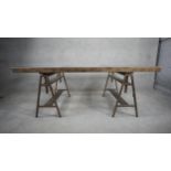 An Andrew Martin metal framed industrial style dining table on twin trestle supports with three