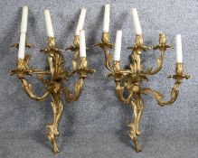 A pair of gilt metal five branch wall candelabras in the Rococo style. H.60cm