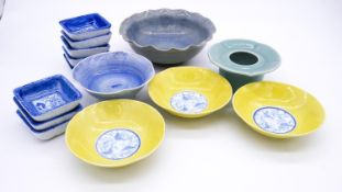 A collection of Oriental glazed ceramics. Including a celadon glaze flower form pot and set of eight