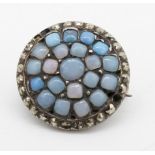 A Georgian opalescent paste stone and marcasite set white metal brooch. Secure hinged pin to the