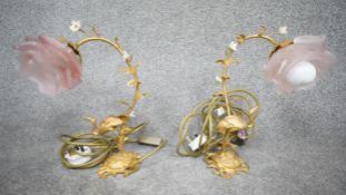 A pair of gilt metal desk lamps with storks to each base, foliate and flowerhead decorated stems and