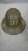 A WW2 Zuckerman painted metal helmet with canvas lining. Numbered and stamped.