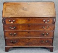 A Georgian mahogany bureau with fall front revealing inlaid fitted interior with secret compartments