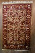 A Ziegler style rug with serrated palm and lotus decoration on a fawn ground within a