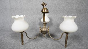 A three branch brass hanging ceiling light with three blown milk glass shades with fluted edge. H.50