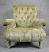 A contemporary Victorian style roll arm easy chair in deep, purple floral buttoned upholstery on