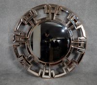 A contemporary circular bevelled glass wall mirror in gilt and glazed geometric styled frame. H.