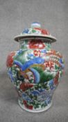 A Chinese Ming-Qing period Transitional Wucai lidded baluster temple jar. Decorated with peonies,