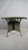 A contemporary John Lewis faux woven wicker garden table on quadruped splay supports. H.108 W.108