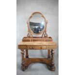 A Victorian mahogany Duchess style dressing table with shaped mirror on baluster turned platform