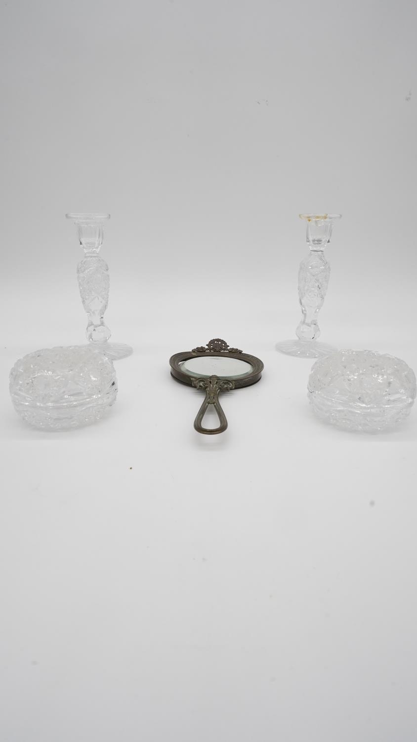 A collection of dressing table items. Including a pair of cut crystal candlesticks, two cut