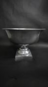 A large pewter pedestal bowl with square base. H.33 W.48 D.48