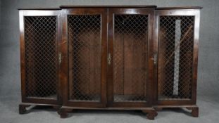 A Georgian style mahogany breakfront dwarf library bookcase with grille doors on shaped bracket