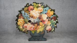 A cut out wooden screen with easel back, with decoupage flowers in a painted urn. Signed A.