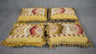 Four tapestry silk backed floral and geometric design cushions with silk tassel edging. Yellow