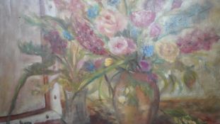 A framed still life oil on canvas of a vase of flowers. Indistinctly signed, inscribed and dated