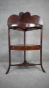 A Georgian mahogany corner washstand with shaped superstructure above undertier fitted with drawer