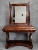 A 19th century Continental flame mahogany dressing table with swing mirror above frieze drawer on