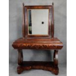 A 19th century Continental flame mahogany dressing table with swing mirror above frieze drawer on