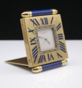 Must de Cartier, a quartz travel clock, the square lacquered brass case with blue enamelled batons