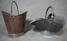 An antique copper coal bucket along with a copper helmet shaped coal scuttle. Both with swing