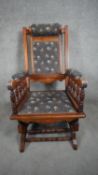 A late 19th century carved walnut American style rocking chair in floral cord upholstery. H.104cm