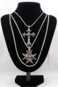 Three silver snake chains, two with pendants. A silver filgree wire work Maltese cross pendant and a