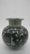 A 20th century Korean celadon glaze ceramic baluster vase with ruffled rim. Decorated with a