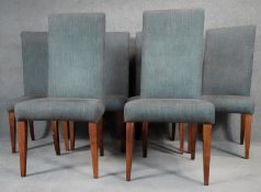 A set of six contemporary high back dining chairs in linen upholstery on square tapering supports.