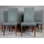 A set of six contemporary high back dining chairs in linen upholstery on square tapering supports.