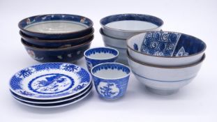 A miscellaneous collection of Chinese blue and white bowls, plates and cups.