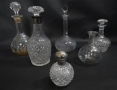 A miscellaneous collection of five 19th century and later decanters, one with a silver collar