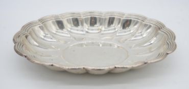 A Cartier scalloped edged gadrooned sterling silver serving dish. Diameter 34cm. Weight 700g.