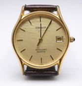 A vintage gold plated Tissot Stylist Quartz watch with brown leather strap. Dial with gold batons