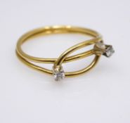 An abstract 18 carat gold wire and diamond ring. Set with two round brilliant diamonds with combined