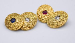 A pair of 18 carat yellow gold gemset textured cufflinks. One set with a cushion shape mixed cut