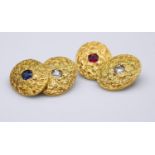 A pair of 18 carat yellow gold gemset textured cufflinks. One set with a cushion shape mixed cut