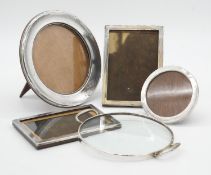 A collection of silver items. Including four silver photo frames (two circular) and a silver