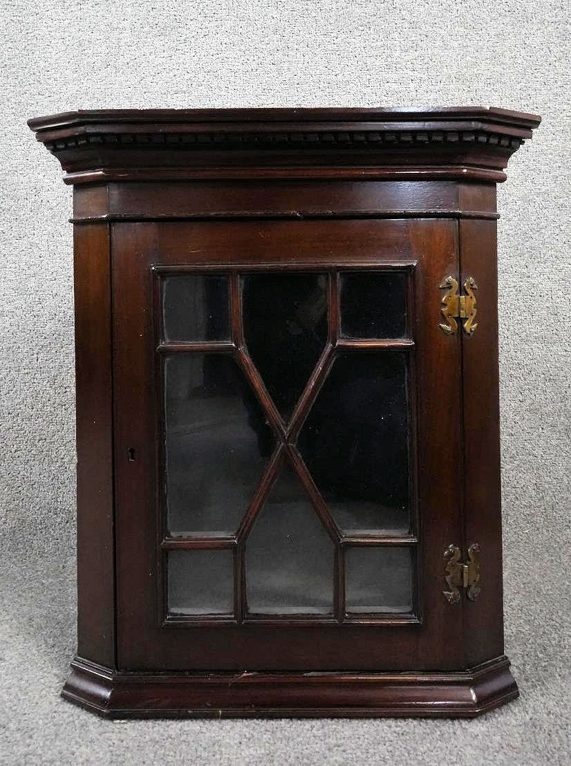A 19th century mahogany hanging corner cabinet with astragal glazed door. H.52 W.44 D.25 (locked and