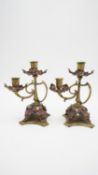 A pair of late 19th century Art Nouveau style brass and copper twin sconce candlesticks with flowing