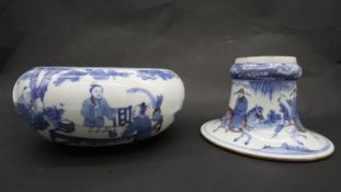 A Chinese Kangxi period porcelain spittoon on stand. Decorated with warriors and immortals. Kangxi