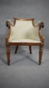 A William IV mahogany framed tub shaped library armchair with scroll arms and geometric upholstery