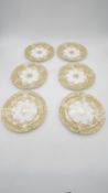 A set of six antique hand painted and gilded porcelain plates with stylised foliate and floral