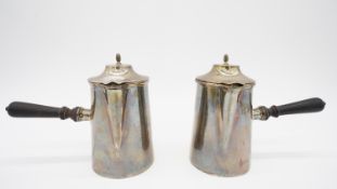 A two piece white metal (tested as silver) cafe au lait set with turned ebony handles. H.14 W.18cm