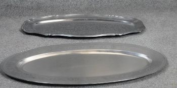 A silver plated oval tray by Guy Degrenne, and a similar tray. W.60cm
