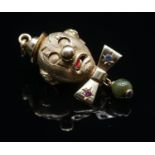 A yellow metal (tested as 9 carat) novelty articulated clown head pendant. The clowns bowtie set