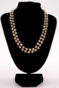 A 1970's long signed Charles de Temple 14 carat yellow gold wrapped knotted cultured pearl necklace.