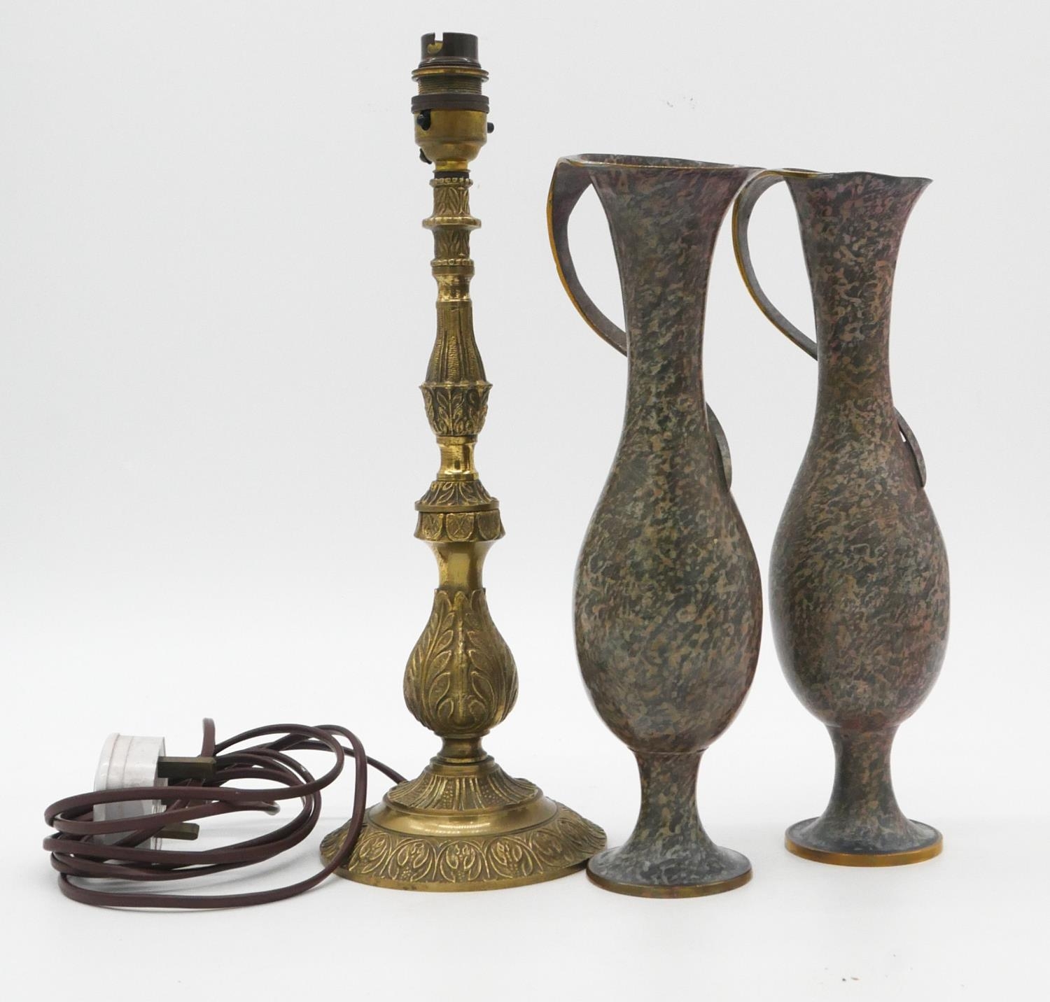 A pair of patinated brass vases with wrapped handles along with a brass foliate design table lamp.