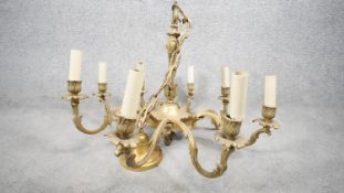 A gilt metal Rococo style eight branch ceiling candelabra. D.60cm