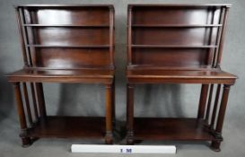 A pair of mid 19th century mahogany bookcases with open upper sections above console bases raised on